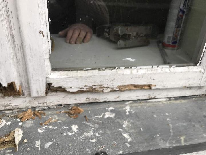Outside view of a casement window with a rotten bottom rail