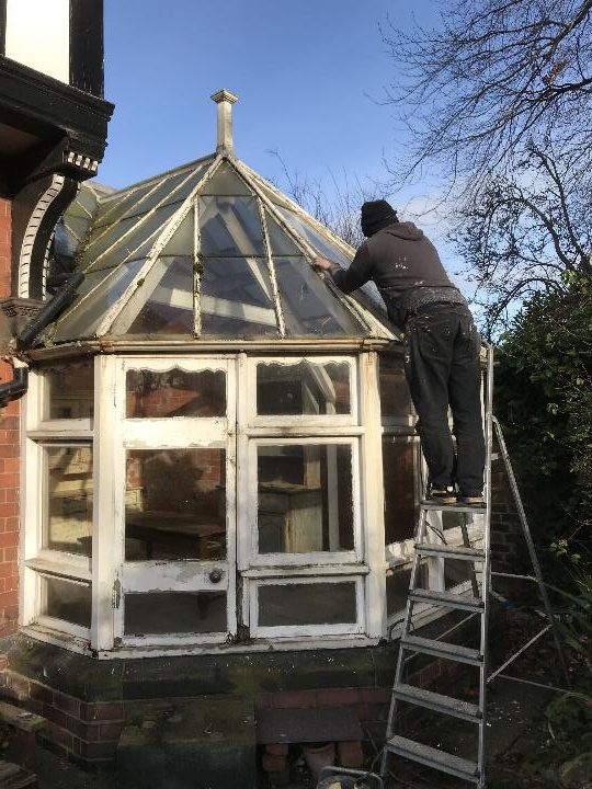 Man repairing a conservatory's roof